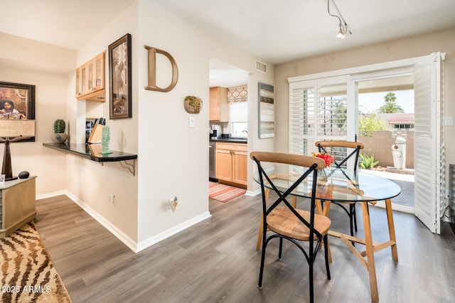 5209 N 78th St, Scottsdale, AZ 85250 - dining area featuring baseboards, wood finished floors, and rail lighting