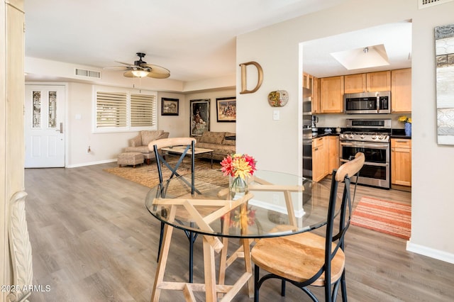 5209 N 78th St, Scottsdale, AZ 85250 - dining space featuring baseboards, light wood-type flooring, and ceiling fan