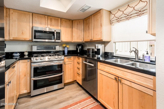 5209 N 78th St, Scottsdale, AZ 85250 - kitchen featuring appliances with stainless steel finishes, light brown cabinets, and light wood finished floors