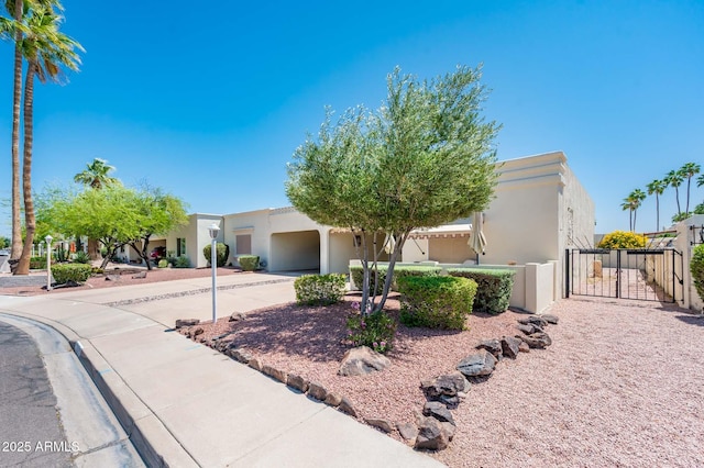 5209 N 78th St, Scottsdale, AZ 85250 - view of front of property featuring stucco siding, driveway, and a gate