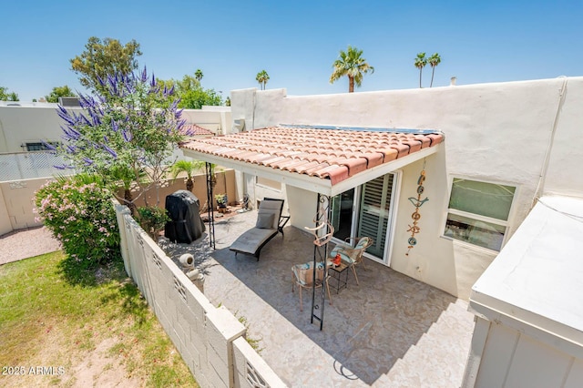 5209 N 78th St, Scottsdale, AZ 85250 - back of property featuring stucco siding, a patio, a fenced backyard, and a tiled roof