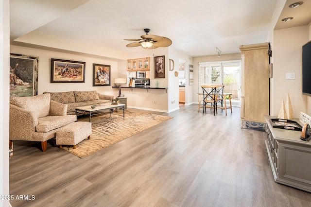 5209 N 78th St, Scottsdale, AZ 85250 - living room with a ceiling fan, wood finished floors, and baseboards