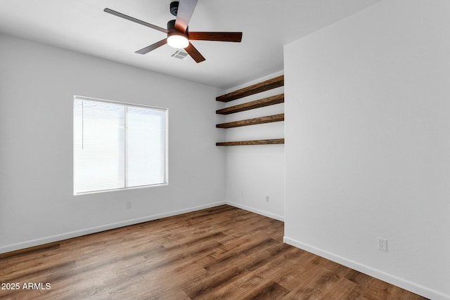 unfurnished room featuring visible vents, ceiling fan, baseboards, and wood finished floors