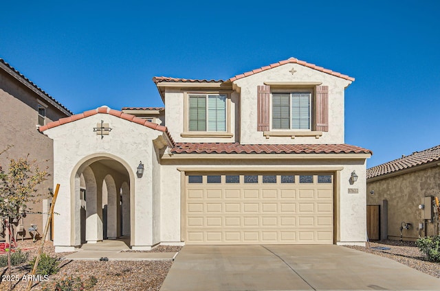 mediterranean / spanish-style house with a garage