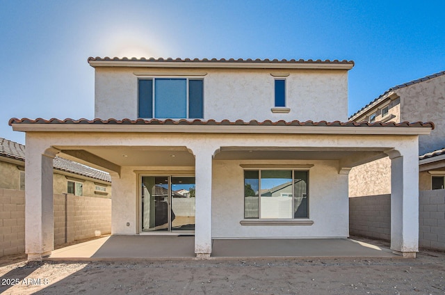 back of property featuring a patio