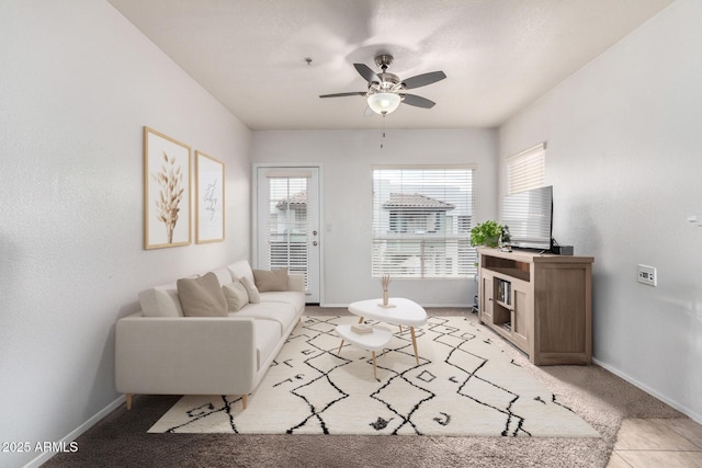 carpeted living room with ceiling fan