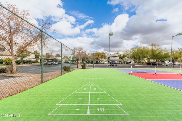 view of community with tennis court