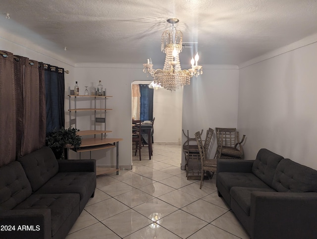 living room with crown molding, a textured ceiling, a notable chandelier, and light tile floors