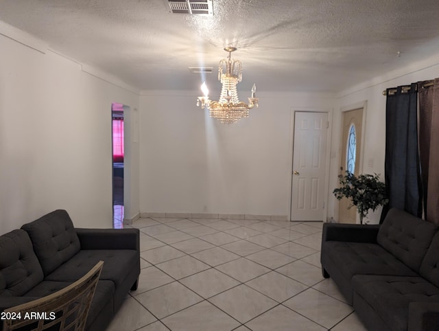 living room featuring a textured ceiling, a notable chandelier, and light tile floors