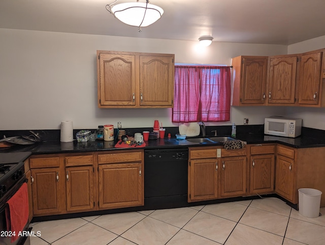 kitchen with stove, black dishwasher, light tile floors, and sink