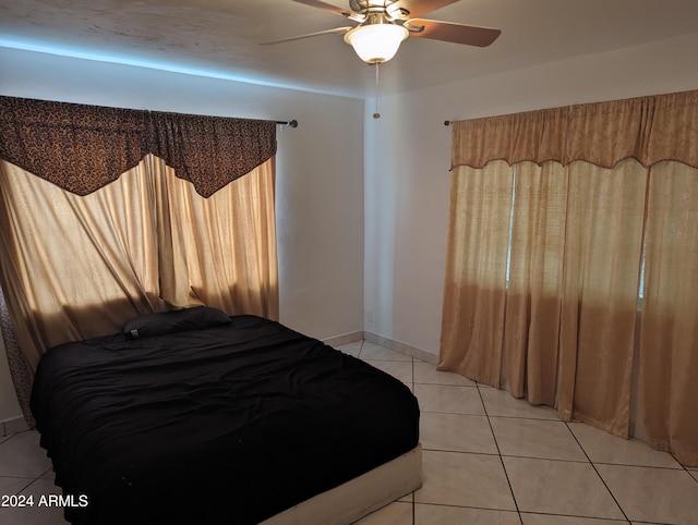 tiled bedroom with ceiling fan