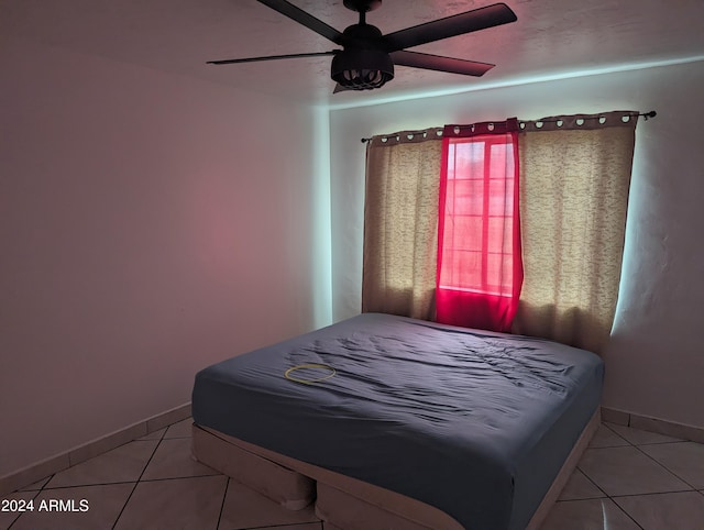 tiled bedroom with ceiling fan