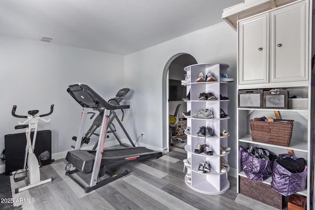 exercise room with hardwood / wood-style floors