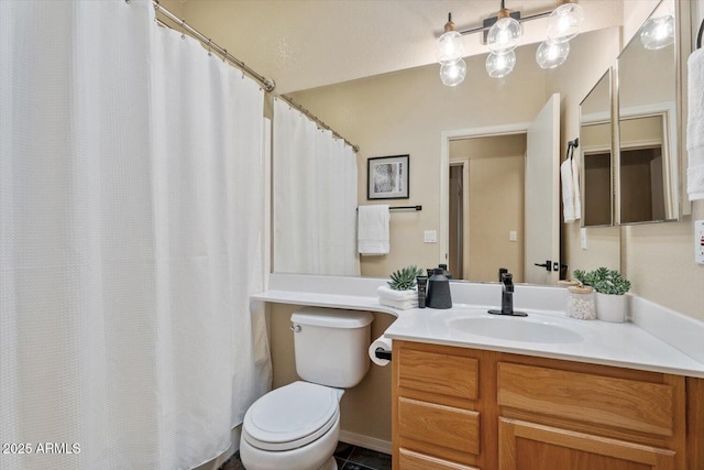 bathroom with tile patterned floors, vanity, and toilet