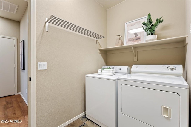 washroom featuring wood-type flooring and independent washer and dryer