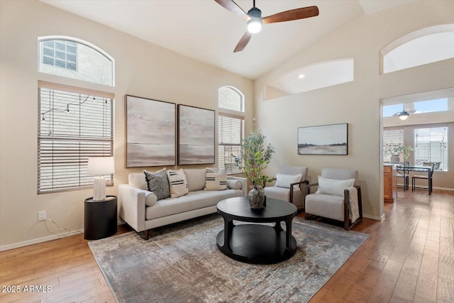 living room with light hardwood / wood-style flooring, ceiling fan, and lofted ceiling