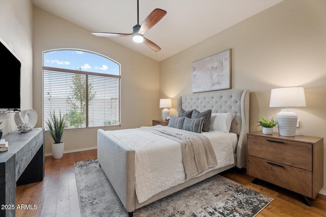 bedroom with hardwood / wood-style flooring, ceiling fan, and lofted ceiling