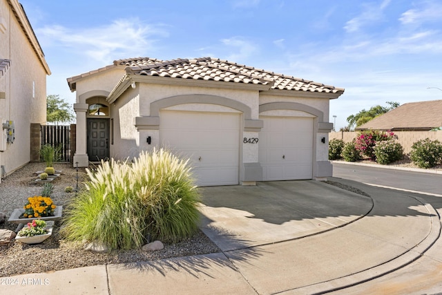 mediterranean / spanish house with a garage