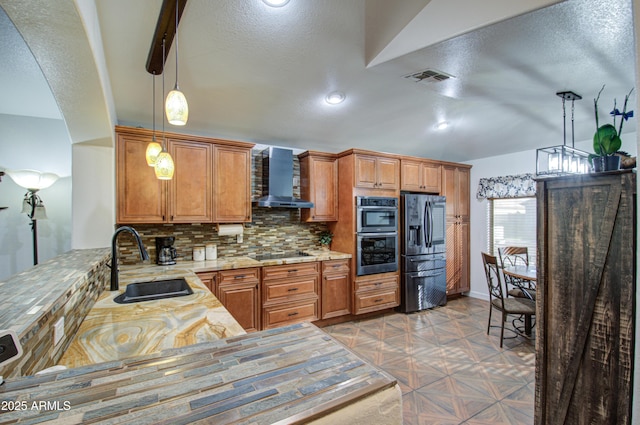 kitchen featuring refrigerator with ice dispenser, sink, backsplash, black electric cooktop, and wall chimney exhaust hood