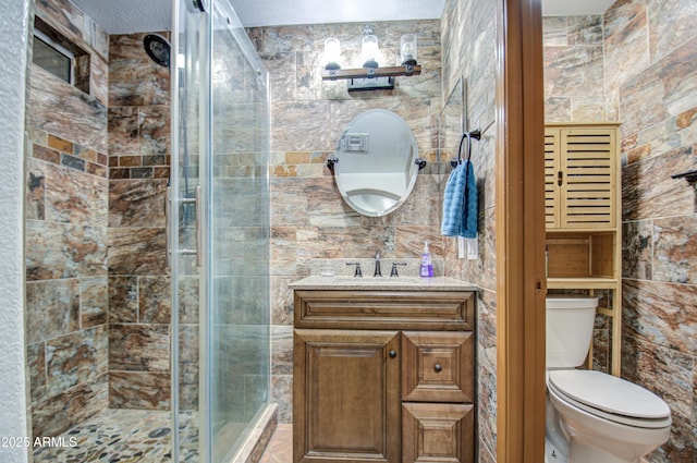 bathroom featuring vanity, walk in shower, and toilet