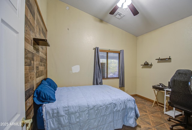 bedroom featuring dark parquet flooring, lofted ceiling, and ceiling fan