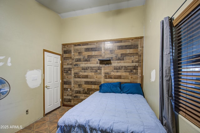 bedroom featuring lofted ceiling and dark parquet flooring