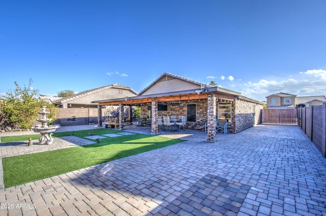 rear view of property featuring a bar and a patio