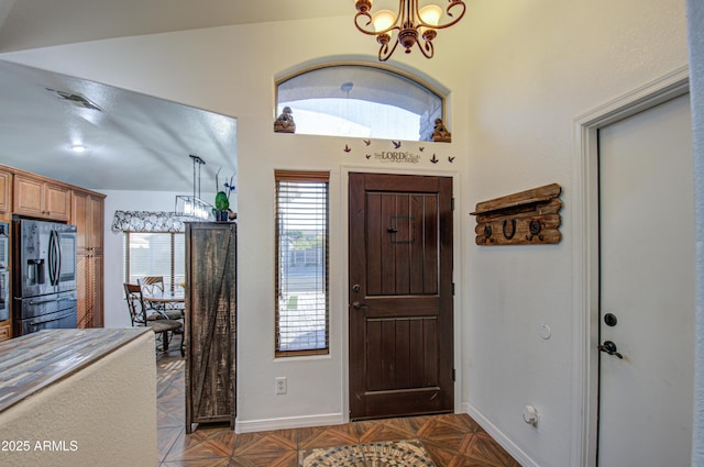 foyer with lofted ceiling and a chandelier