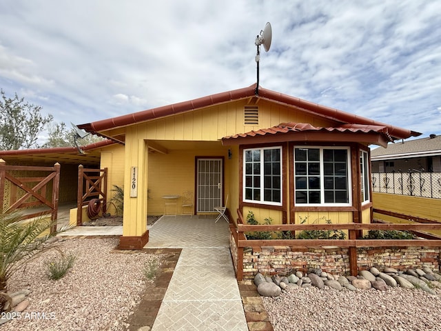 rear view of property with a patio and fence