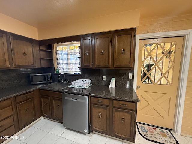 kitchen featuring open shelves, a sink, decorative backsplash, stainless steel appliances, and dark brown cabinets