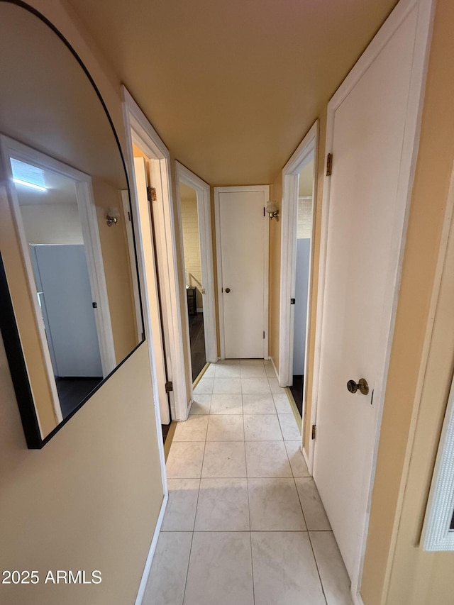 hall with light tile patterned floors