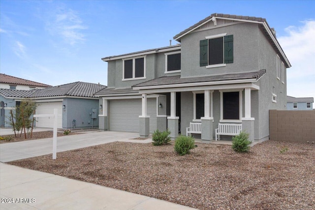 view of front of house with a garage and a porch