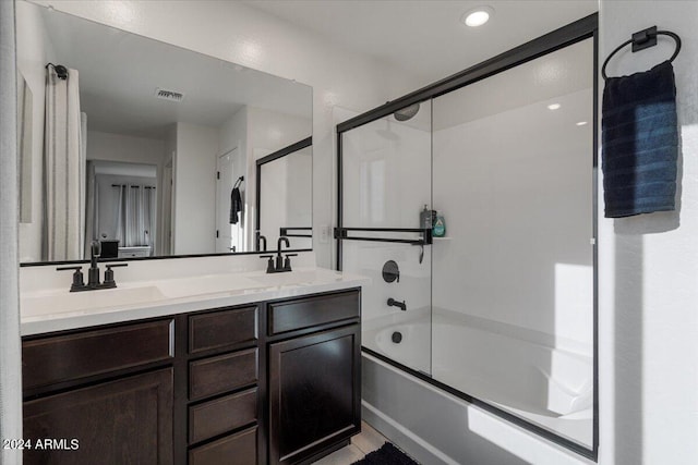 bathroom with vanity and enclosed tub / shower combo