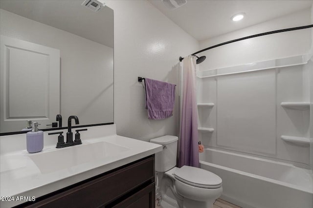 full bathroom with vanity, toilet, and shower / tub combo