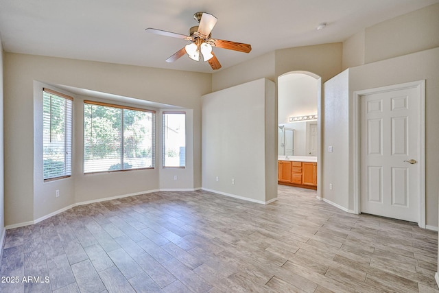 unfurnished room with light wood-style flooring, baseboards, and ceiling fan