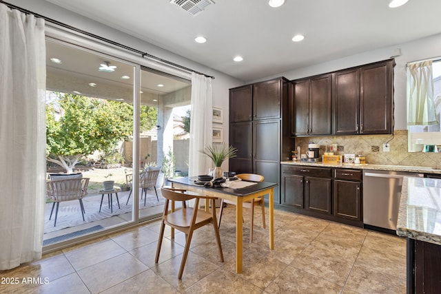 kitchen featuring light tile patterned flooring, dark brown cabinetry, tasteful backsplash, light stone counters, and dishwasher