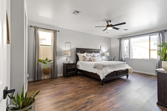 bedroom with dark hardwood / wood-style floors and ceiling fan