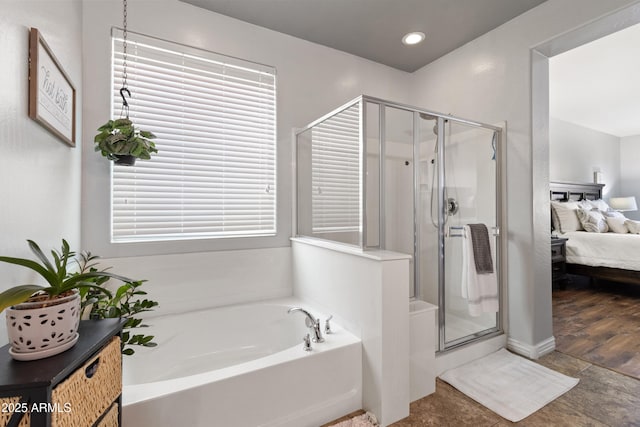 bathroom featuring independent shower and bath