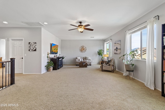 sitting room with ceiling fan and carpet flooring