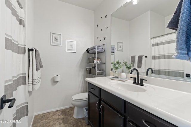 bathroom featuring tile patterned floors, vanity, and toilet