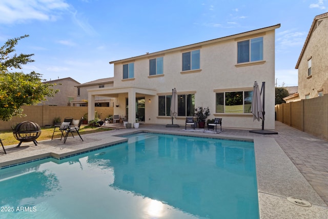 view of pool featuring a patio area and a fire pit