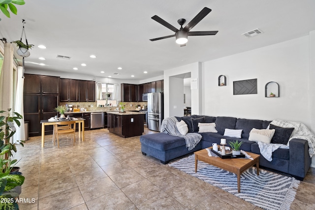 living room featuring ceiling fan and light tile patterned floors