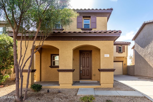 mediterranean / spanish-style home with a garage