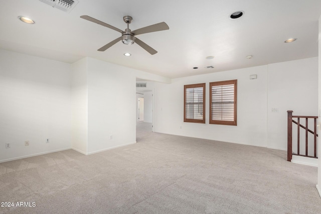 carpeted spare room with ceiling fan