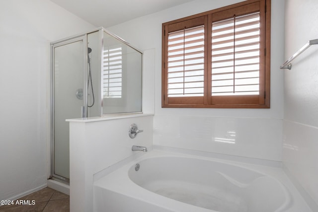 bathroom featuring tile patterned flooring and independent shower and bath