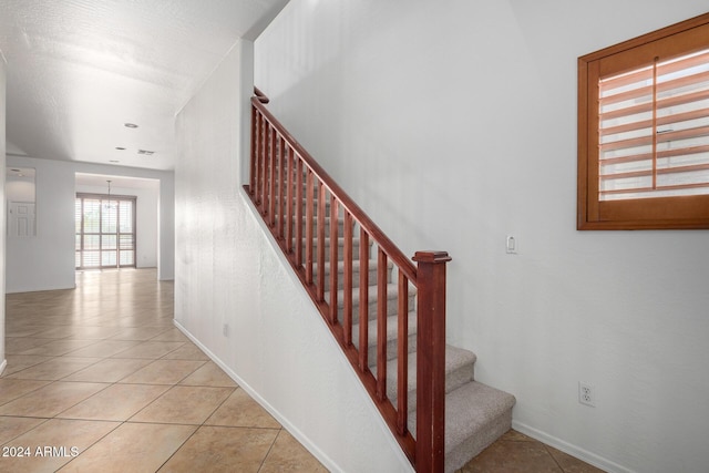 staircase with tile patterned flooring