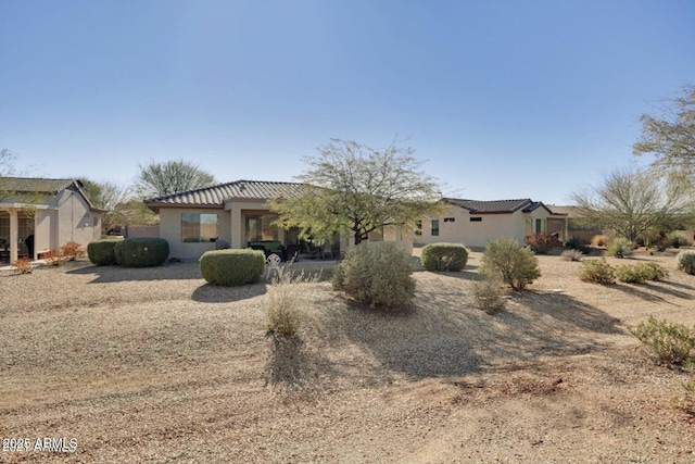 view of front of home with stucco siding and a tile roof