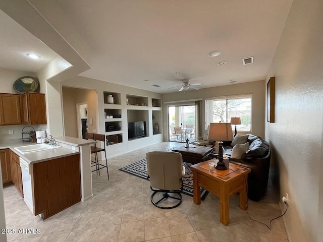 living room with ceiling fan, built in shelves, recessed lighting, light tile patterned floors, and visible vents