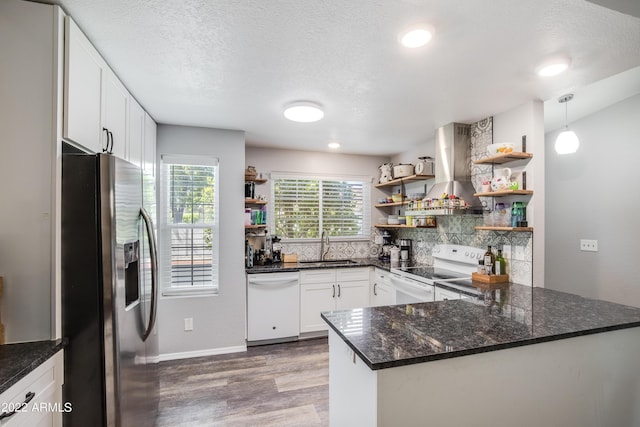 kitchen featuring range hood, stainless steel refrigerator with ice dispenser, range with electric stovetop, white dishwasher, and white cabinets