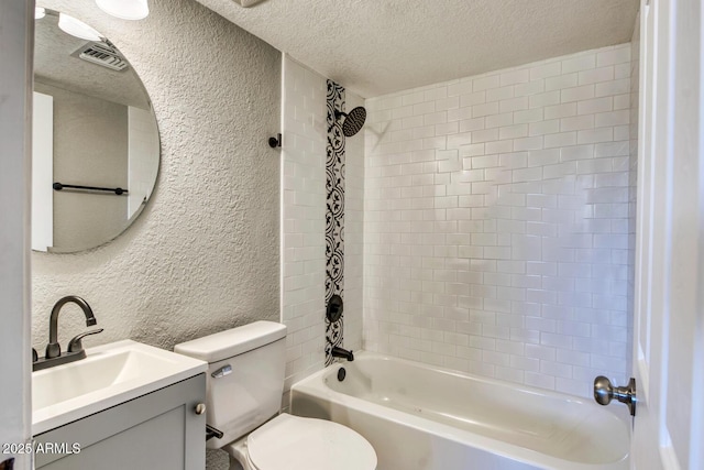 bathroom featuring a textured ceiling, a textured wall, toilet, visible vents, and washtub / shower combination